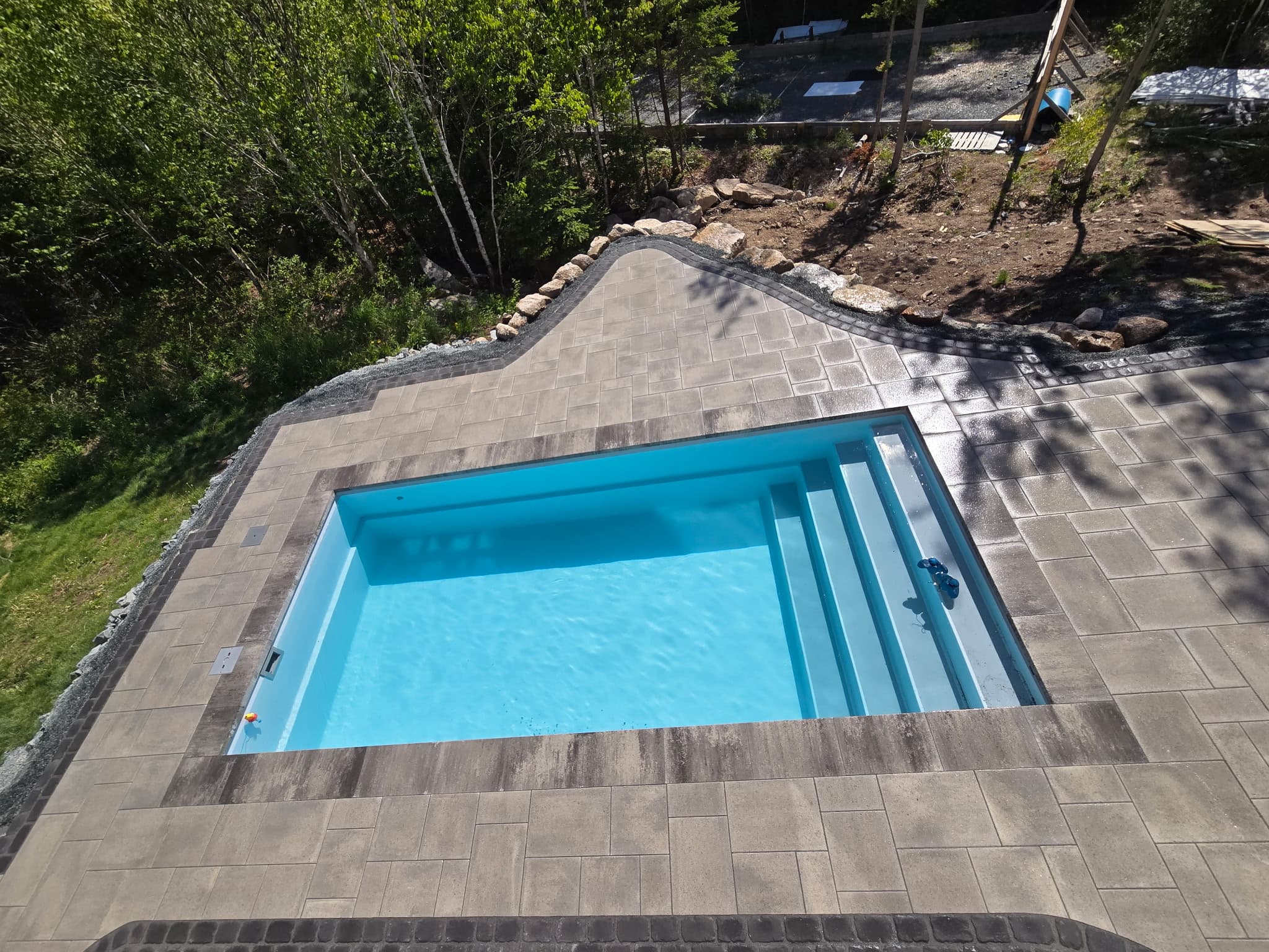 Custom fiberglass plunge pool with paver surround