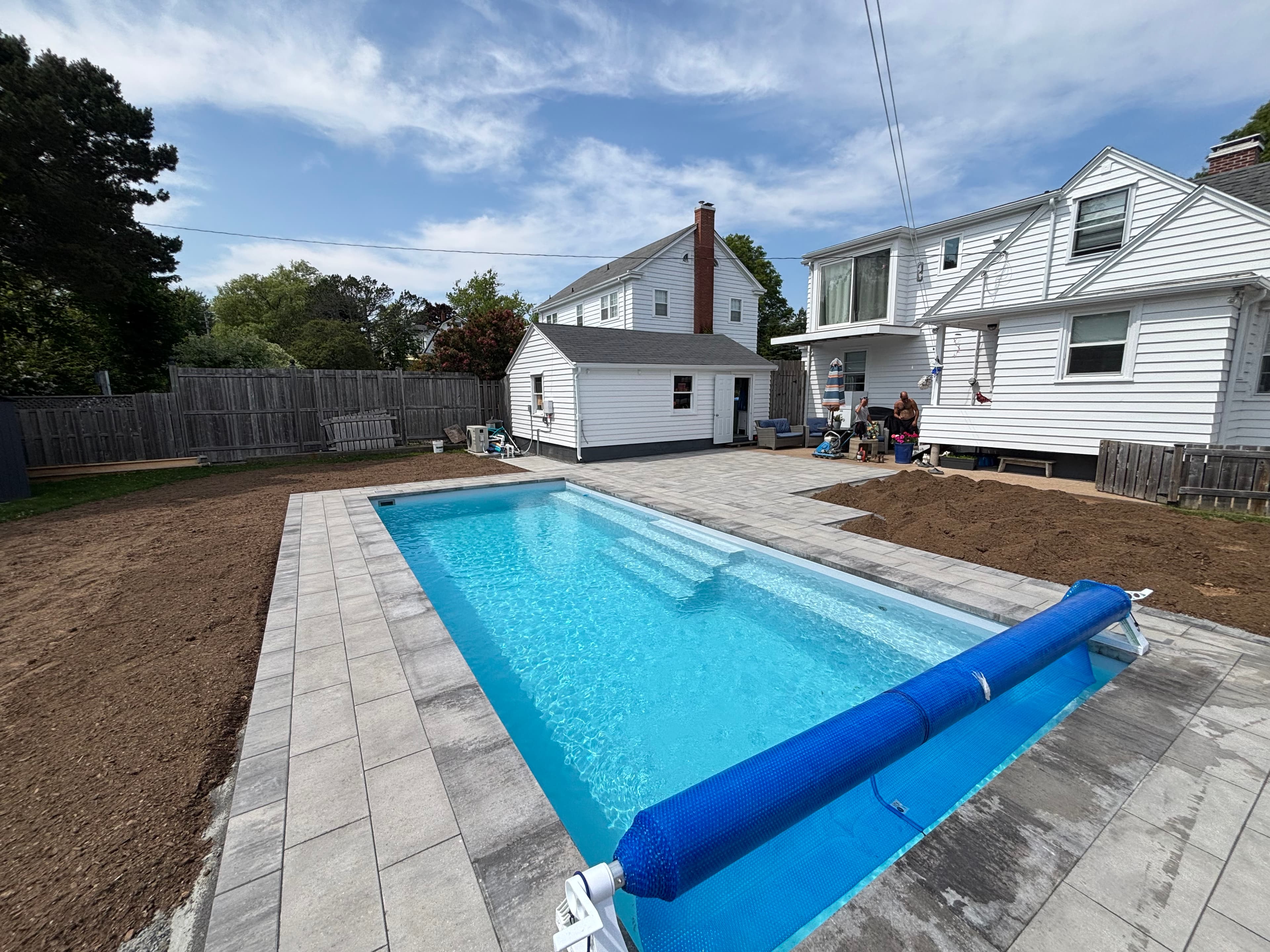 New plunge pool installation with grey and black paver border