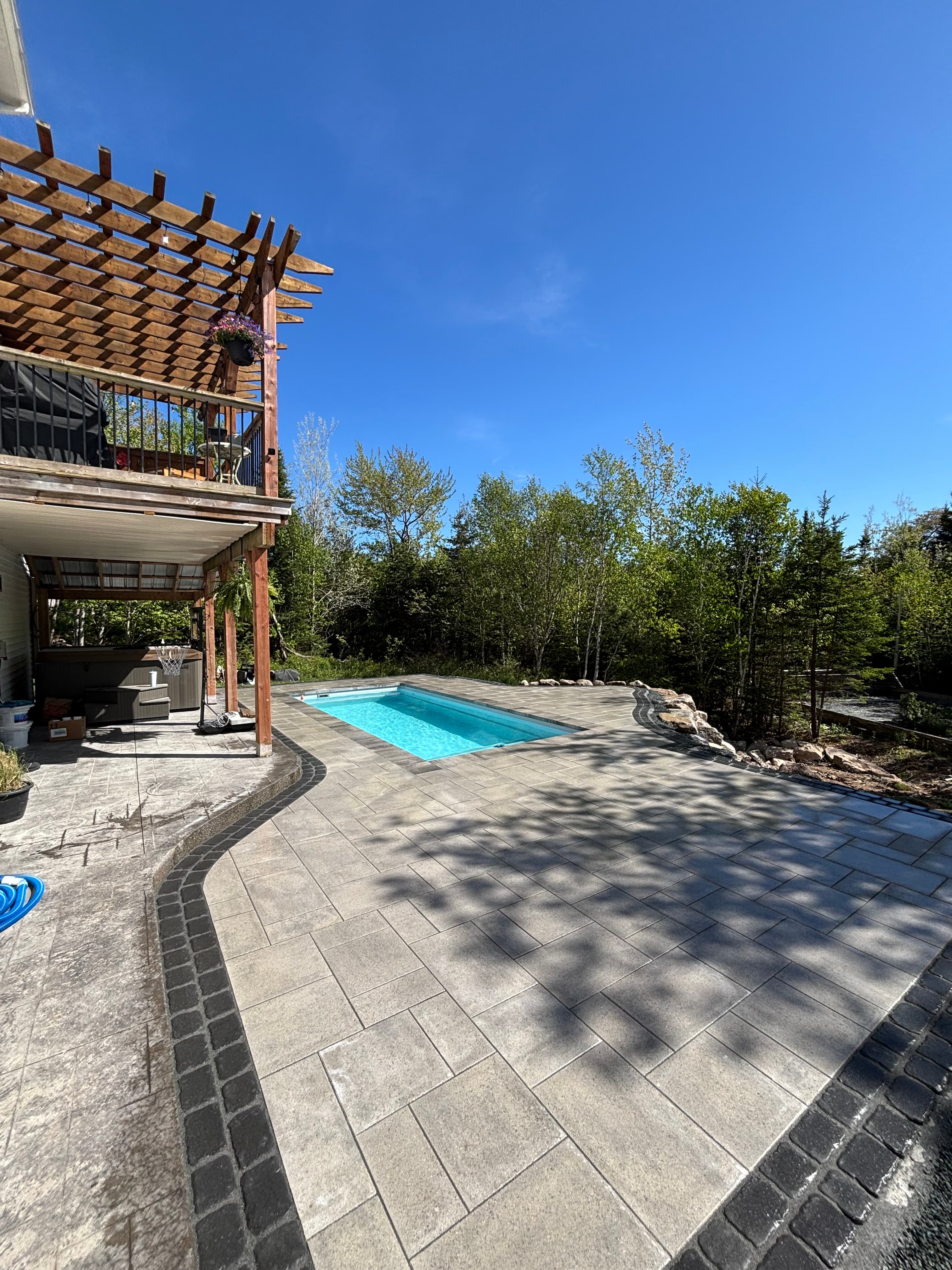 Plunge pool with pergola and interlocking paver patio