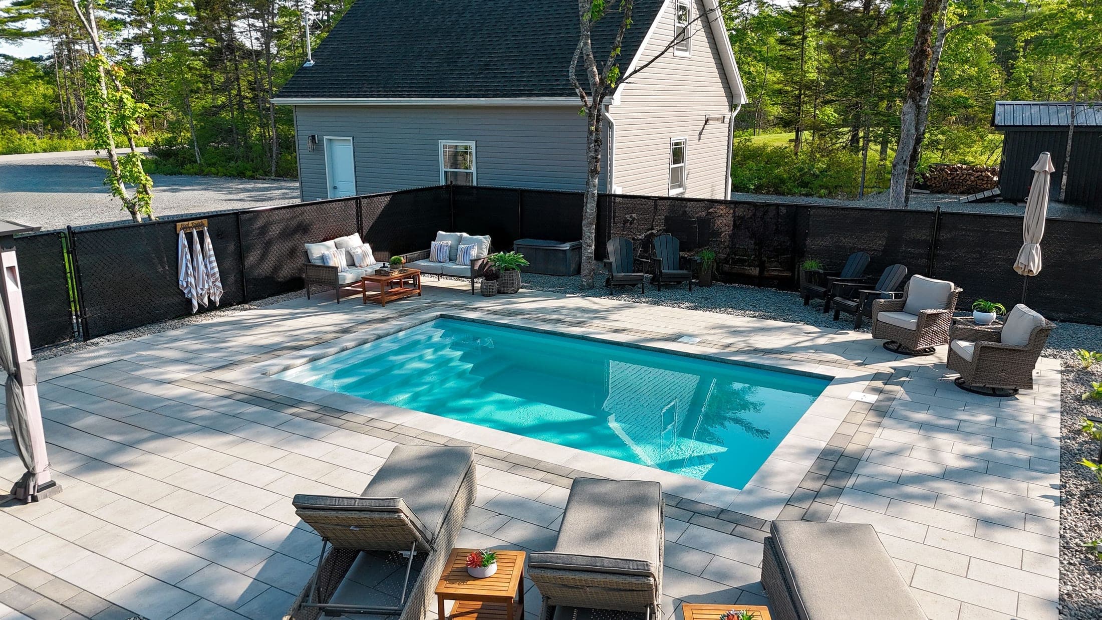 Pool installation with stone patio and seating