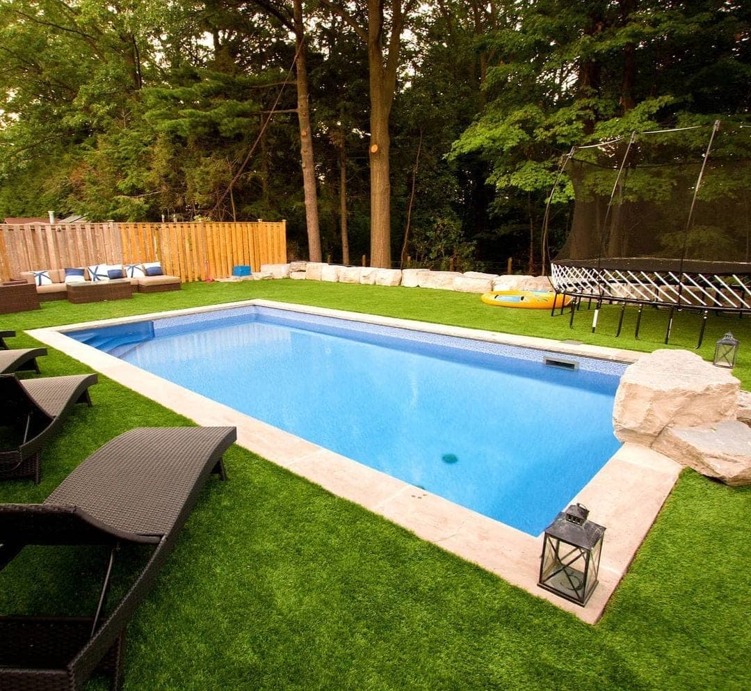 Pool with trampoline and lounge area
