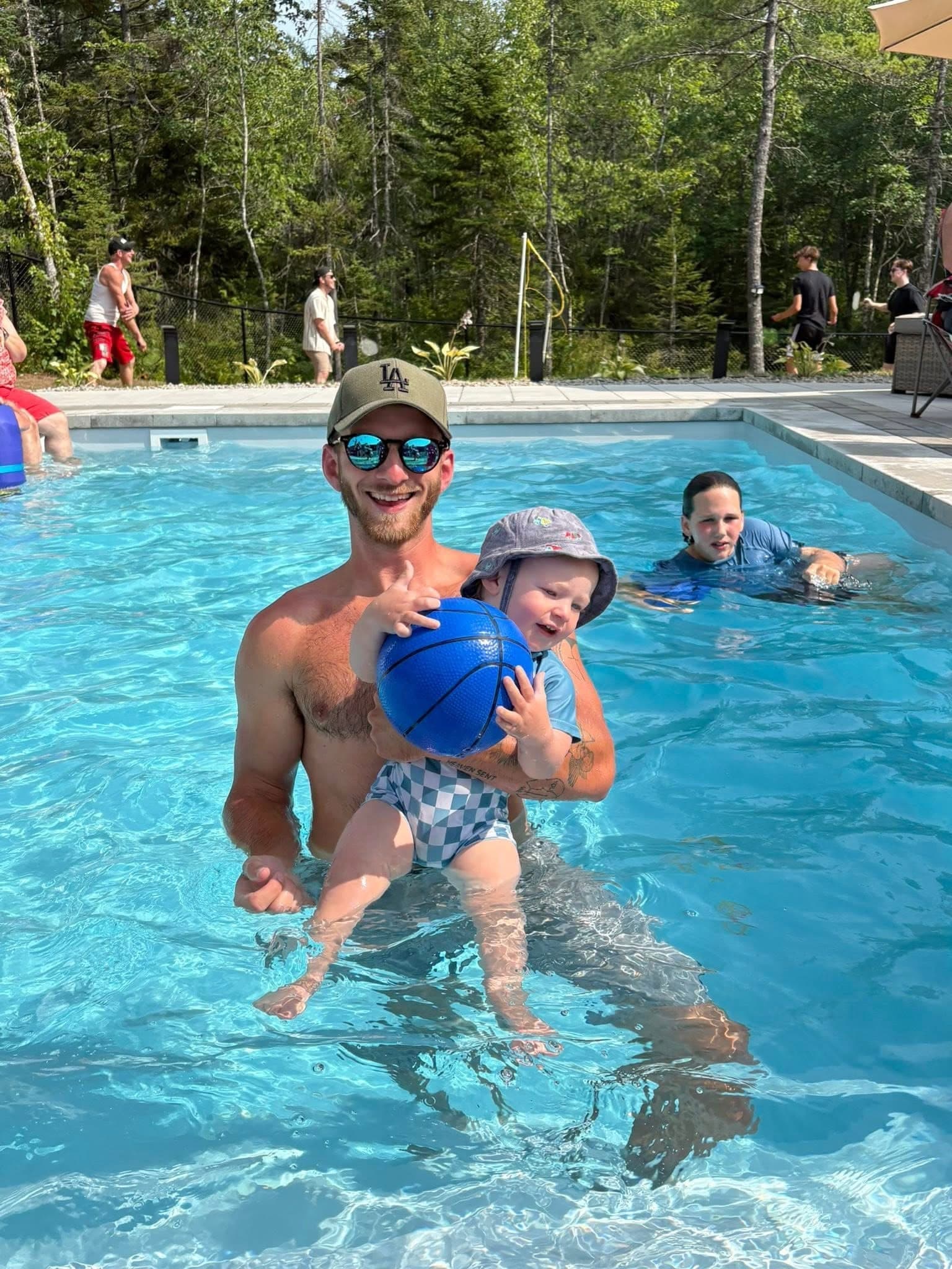 Spencer Book, owner of Ocean View Plunge Pools, in a finished pool with his son